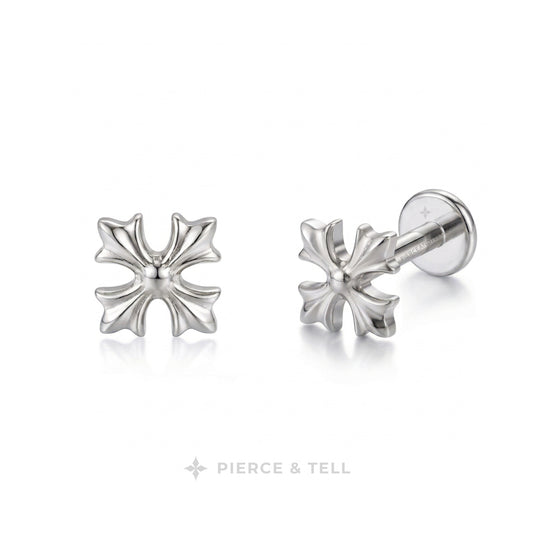 A pair of silver-toned cross-shaped stud earrings by Pierce & Tell, one shown from the front and the other from the side/back, on a clean white background.