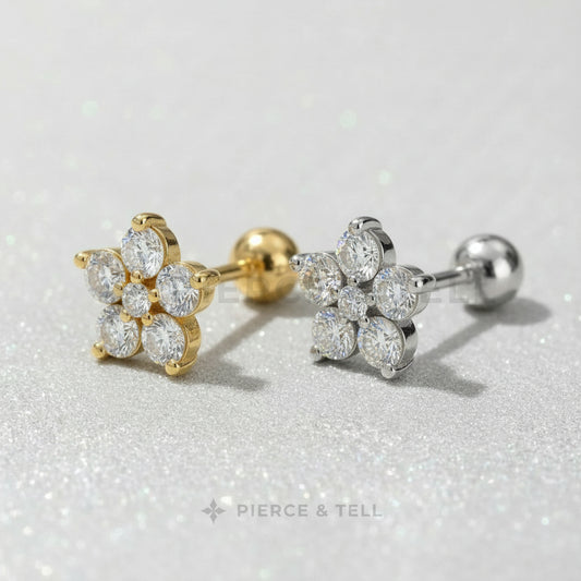 Gold and silver earrings with clear gemstones on a light gray background, branded 'Pierce & Tell'.