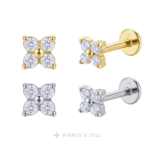Four close-up views of a pair of stud earrings on a white background: two front views in yellow gold and two side views in silver. Each earring has a four-petal floral setting with clear gemstones and a central round stone.