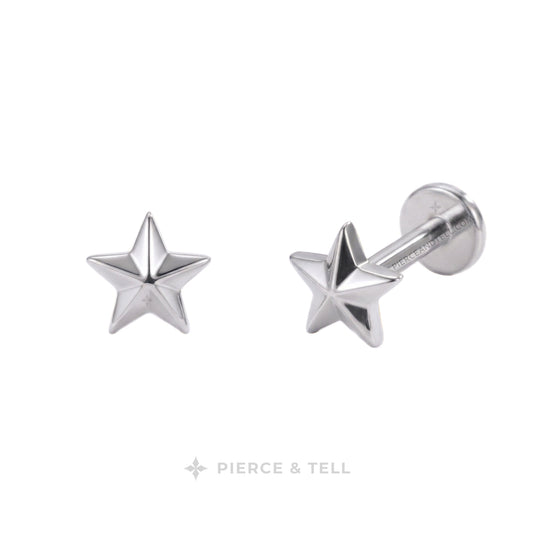 A pair of silver star-shaped labret stud earrings by Pierce & Tell, shown on a clean white background with one earring facing forward and the other angled to show the post and backing.