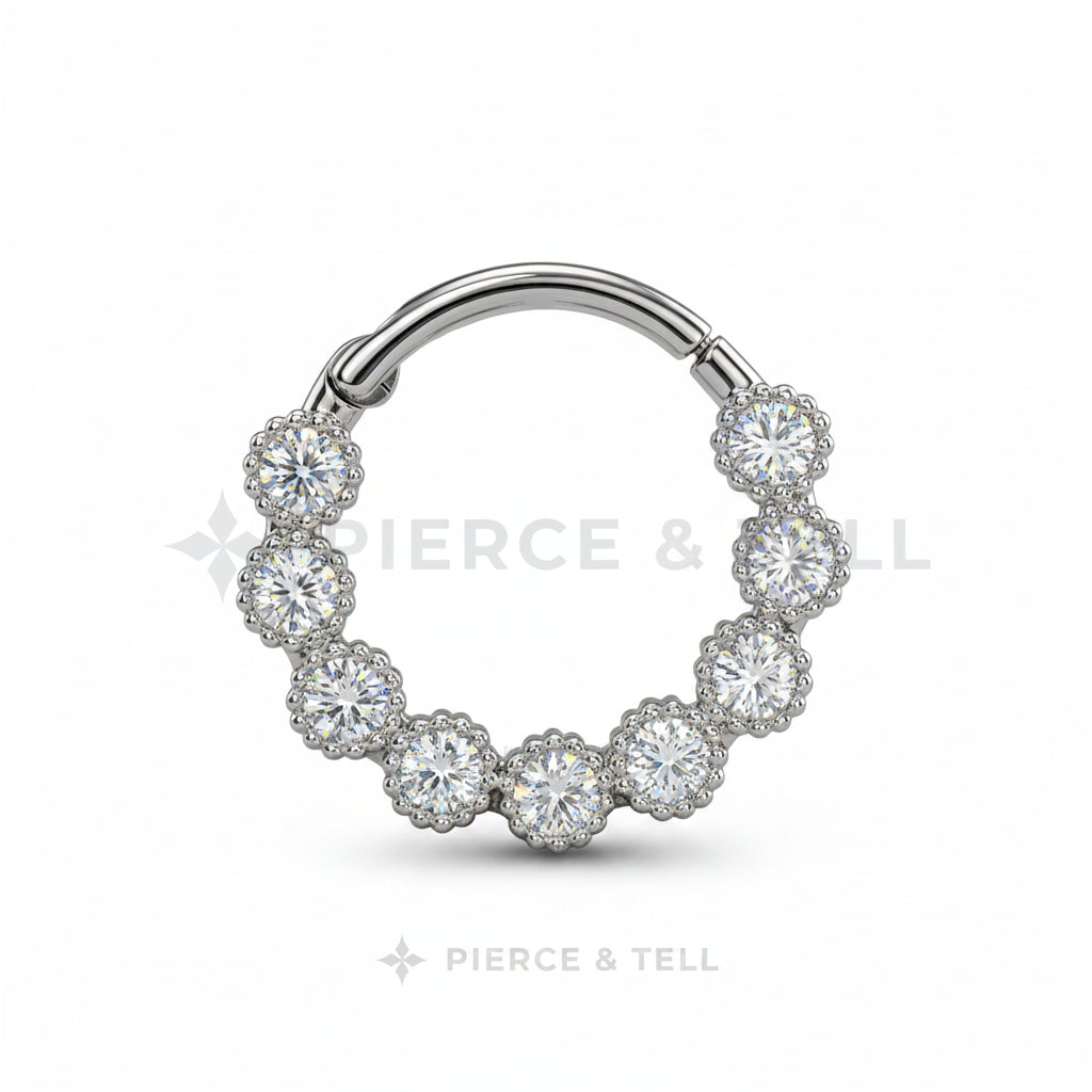 Silver hoop earring with clear gemstones on a white background