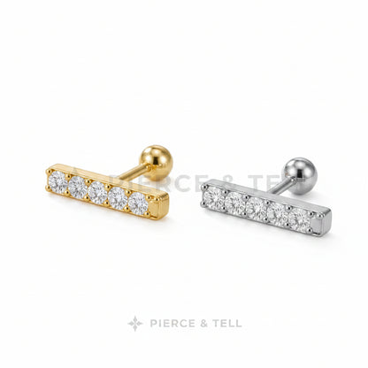 Two gold and silver bar-shaped earrings with clear stones on a light gray background.