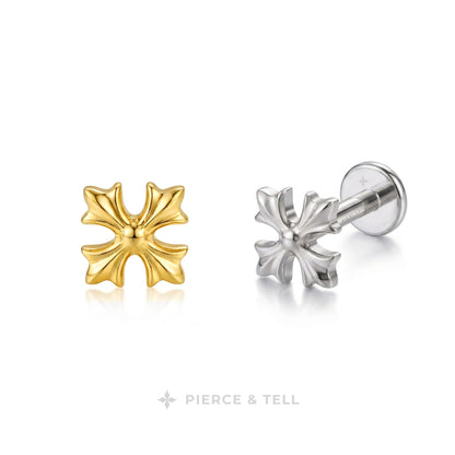Two small cross-shaped stud earrings on a clean white background, one in yellow gold and one in silver with a visible post and backing. The brand name PIERCE & TELL appears below.