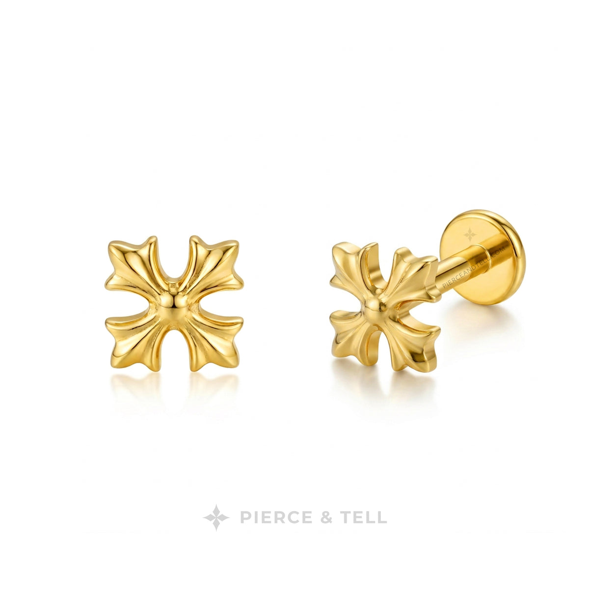 A pair of gold cross-shaped stud earrings by Pierce & Tell, shown on a clean white background with a soft reflection. One earring is facing forward, and the other is angled to show the post and backing.