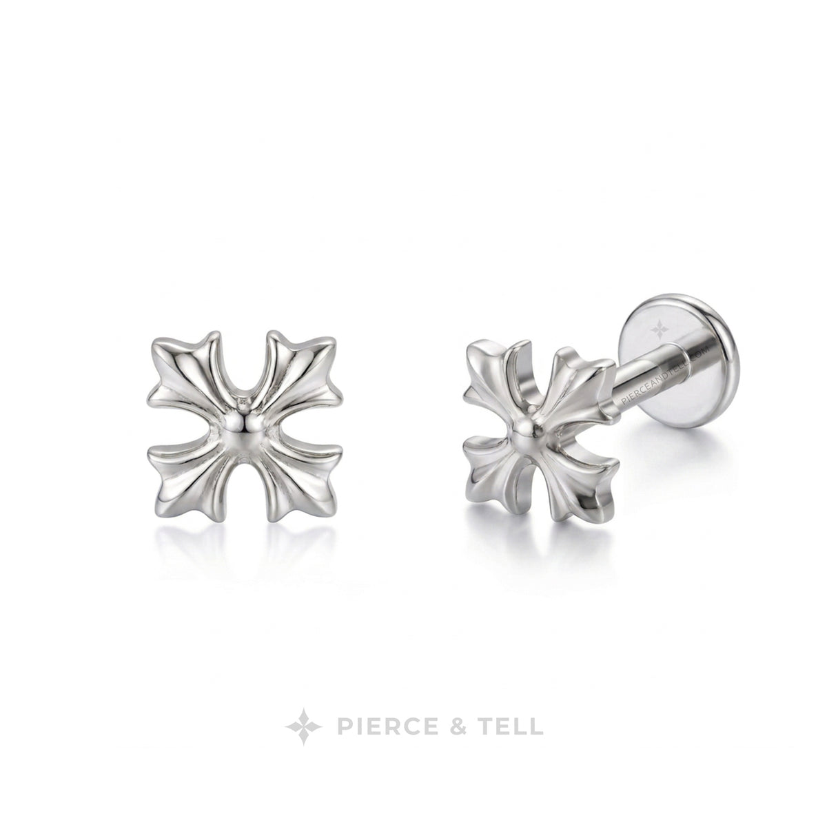 A pair of silver-toned cross-shaped stud earrings by Pierce & Tell, one shown from the front and the other from the side/back, on a clean white background.