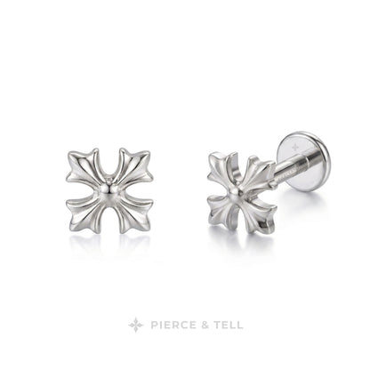 A pair of silver-toned cross-shaped stud earrings by Pierce & Tell, one shown from the front and the other from the side/back, on a clean white background.