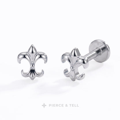 A pair of silver French fleur-de-lis barbell stud earrings by Pierce & Tell, shown on a clean white background with one earring facing forward and the other angled to show the post and flatback end.