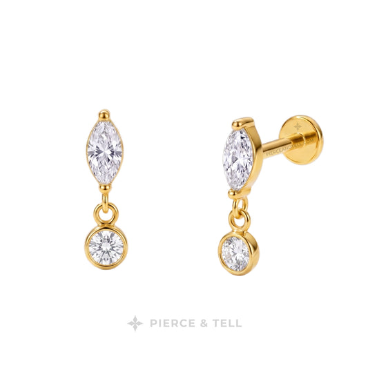 A pair of gold drop earrings with marquise-cut clear gemstones and round clear gemstones, shown on a white background with the PIERCE & TELL logo at the bottom.