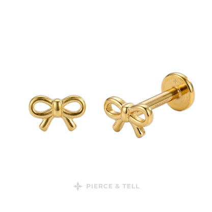 A pair of gold bow stud earrings shown on a plain white background with the brand name 'PIERCE & TELL' at the bottom.