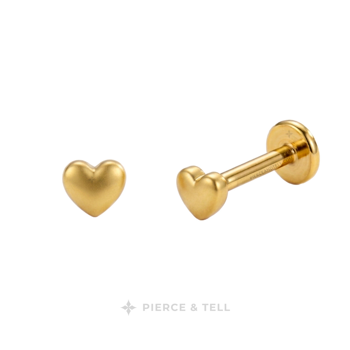 Gold heart-shaped labret stud earrings shown from front and side angles on a white background, with the PIERCE & TELL logo at the bottom.