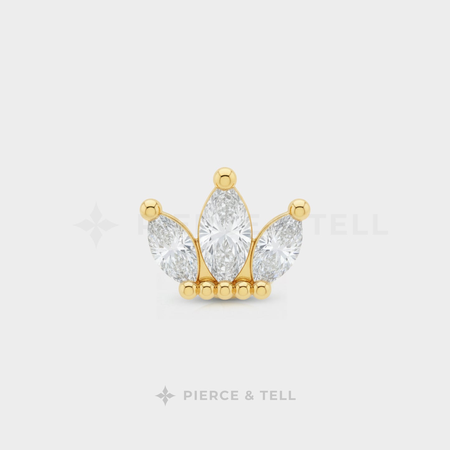 Gold and diamond earring on a white background with 'Pierce & Tell' branding.