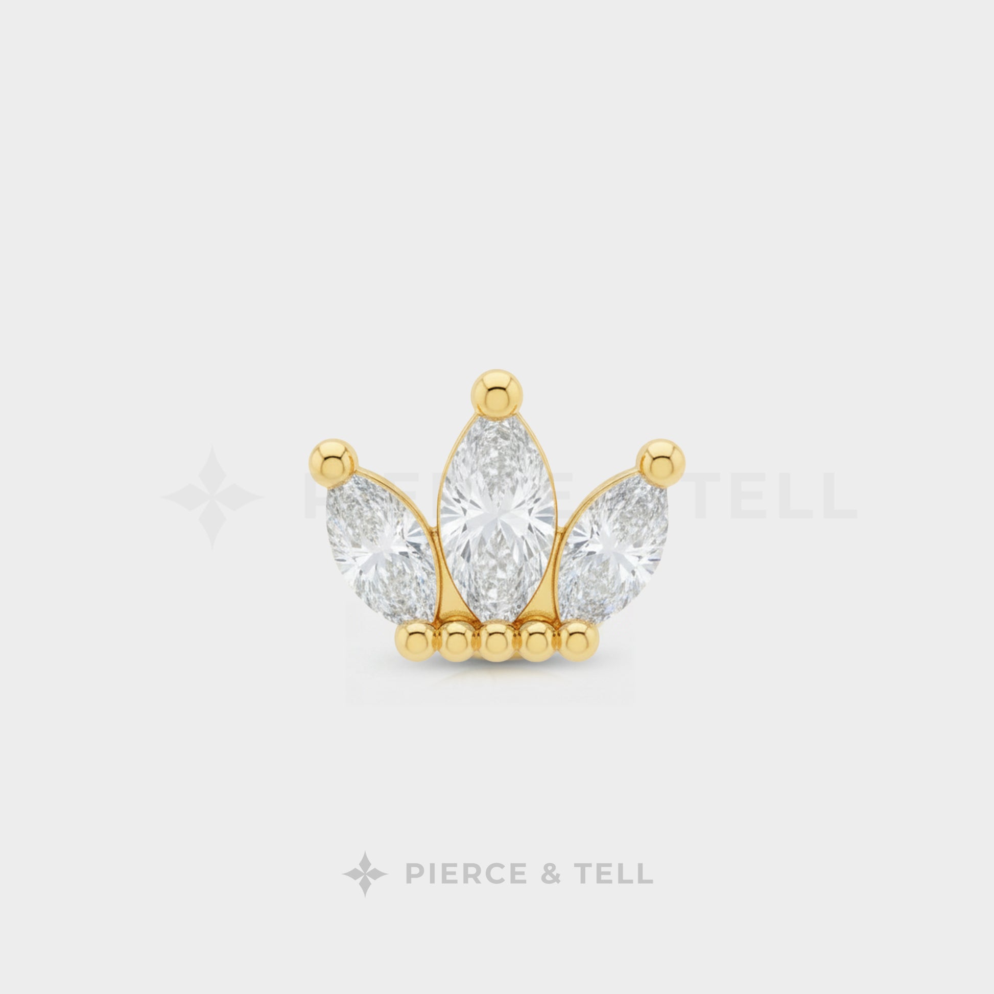 Gold and diamond earring on a white background with 'Pierce & Tell' branding.