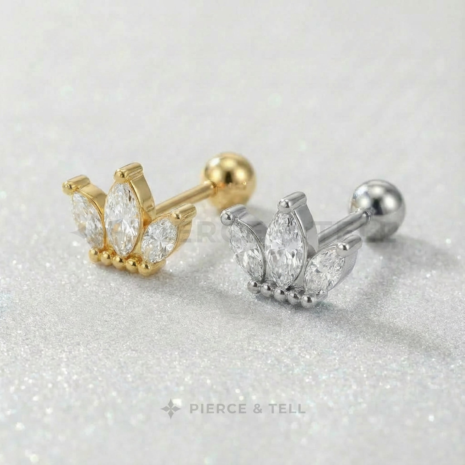 Gold and silver earrings with gemstones on a glittery surface, branded 'Pierce & Tell'.