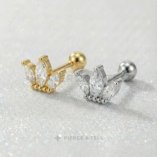 Gold and silver earrings with gemstones on a glittery surface, branded 'Pierce & Tell'.