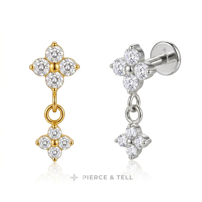 Two pairs of diamond drop earrings shown on a white background, one in yellow gold and one in silver. Each earring features a four-petal flower cluster with a dangling smaller flower motif.