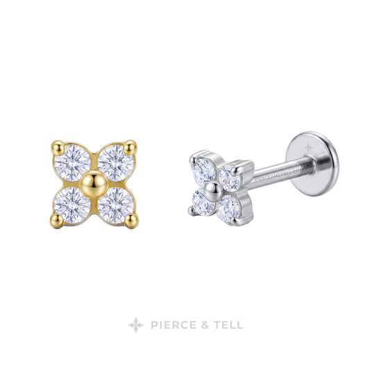 Four stud earrings shown on a white background, each in a different metal finish: yellow gold, white gold, silver, and platinum. Each earring features two round clear gemstones in a prong setting.