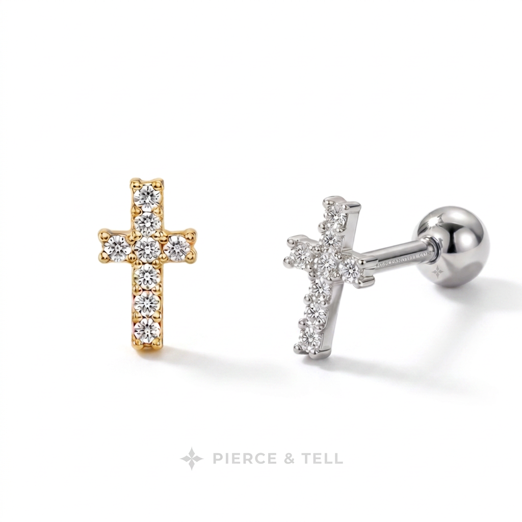 Two cross-shaped stud earrings on a white background, one in yellow gold with clear stones and one in silver with clear stones, with the brand name 'PIERCE & TELL' at the bottom.