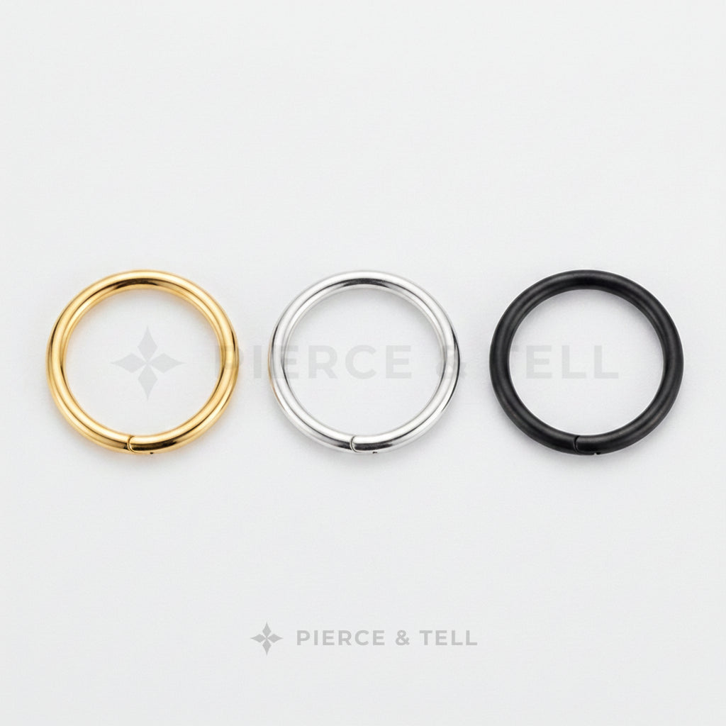 Three circular rings in gold, silver, and black on a white background with 'Pierce & Tell' branding.