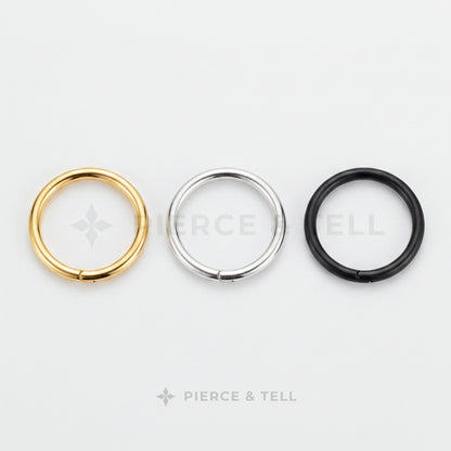 Three circular rings in gold, silver, and black on a white background with 'Pierce & Tell' branding.