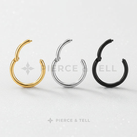 Three hoop earrings in gold, silver, and black on a textured gray background with 'Pierce & Tell' branding.